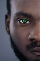 Close-up view of afro-american man eyes blinking and looking straight. Detailed portrait of confident and calm black guy staring at camera.